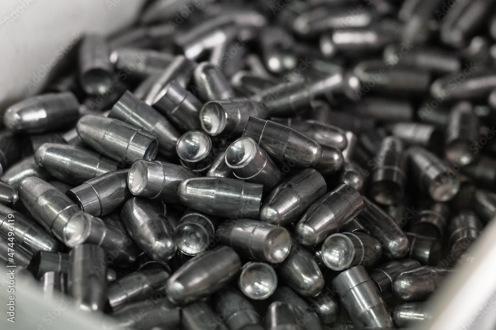 Pile of small caliber hunter bullets in plastic container Pile of small caliber hunter bullets in plastic container
