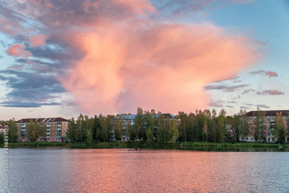 Fototapeta premium A large bright cloud at sunset over the pond