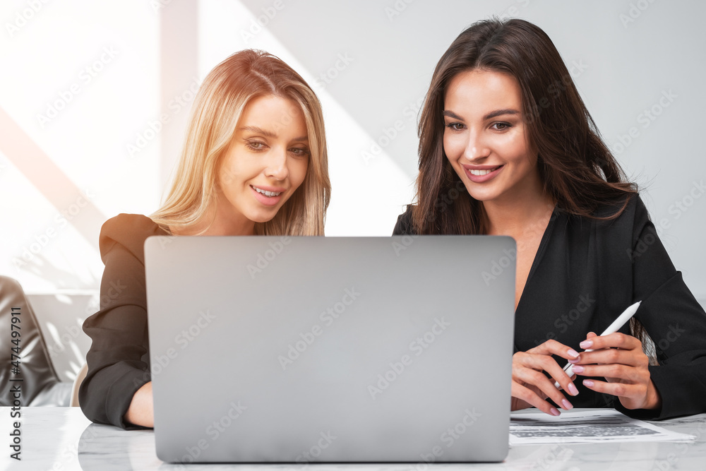 Businesswomen wearing formal suits make contract for a profitable deal Businesswomen wearing formal suits make contract for a profitable deal