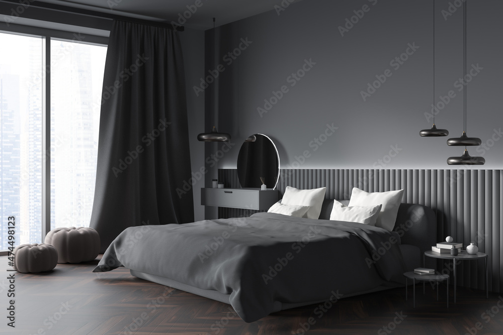 Dark bedroom interior with empty grey wall, bed, coffee table Stock