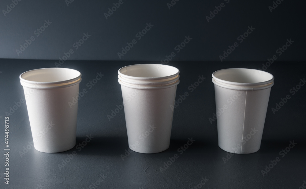 white mock up disposable cup or goblet for branding on grey rustic background . white mock up disposable cup or goblet for branding on grey rustic background .
