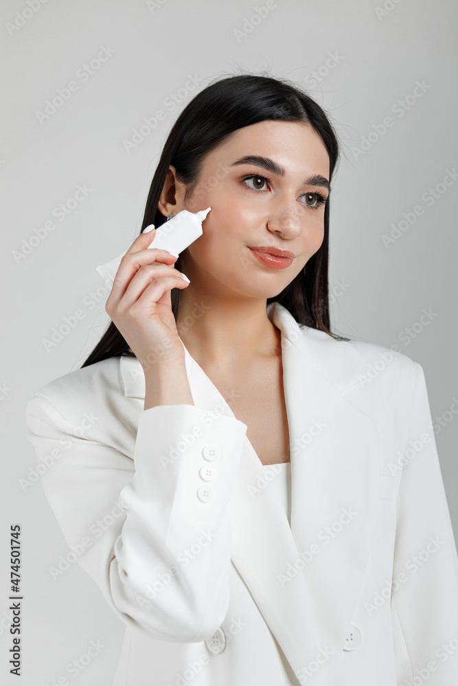 Young good looking girl putting some micellar water on her face to clear the makeup Young good looking girl putting some micellar water on her face to clear the makeup