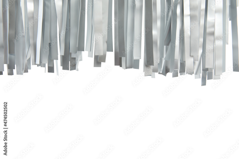 Shiny silver tinsel on white background, closeup Shiny silver tinsel on white background, closeup