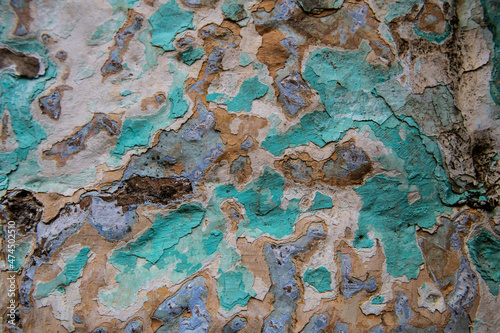 Abstract detail of multi-colored layers of cracked and peeling paint on the side of an old building. © Yehoshua Halevi