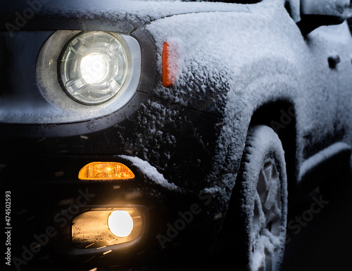 Car lights in winter on the road photo