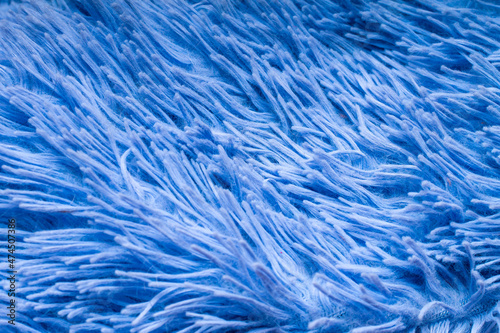 close-up of the villi and pile of a plush plaid or rug of a pale blue color for the decoration of backdrops