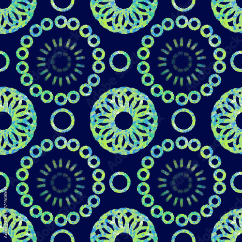 Seamless geometric pattern of mandalas, circles. Multicolored green ornament on a blue background, hand-drawn. Retro style. Design of the background, interior, wallpaper, textiles, fabric, packaging.