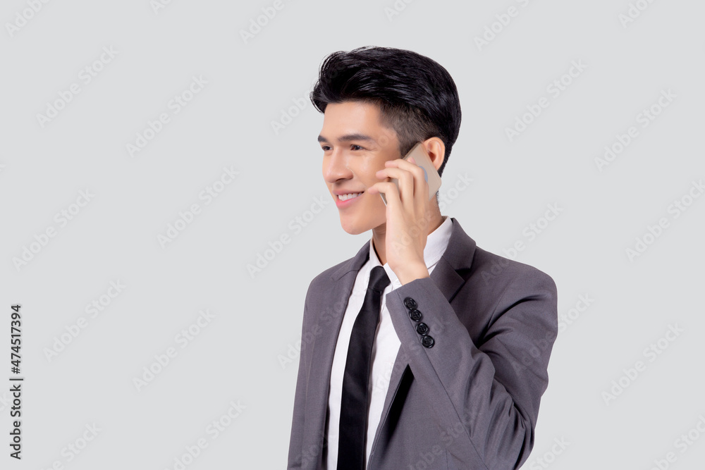 Young asian business man in suit talking on mobile phone isolated on white background, businessman speaking and listening smartphone with conversation, male holding cell phone, communication concept. Young asian business man in suit talking on mobile phone isolated on white background, businessman speaking and listening smartphone with conversation, male holding cell phone, communication concept.
