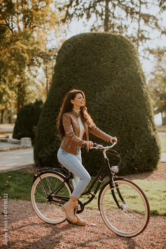 Young woman riding bicycle ...