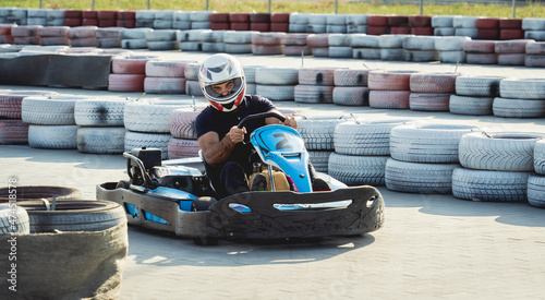 A young man drives a go kart at circuit