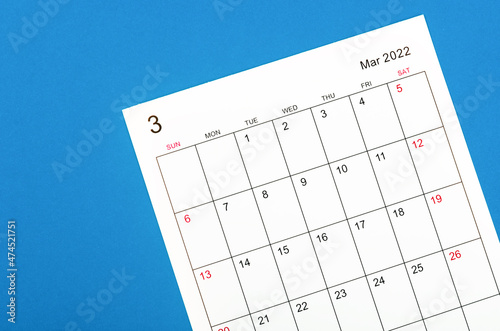 March 2022 calendar sheet on blue background. © gamjai