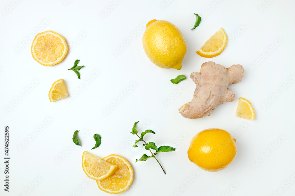 Fresh ginger and lemon on white background. Flat lay, top view, copy space. Seasoning, spice, ingredient for tea
