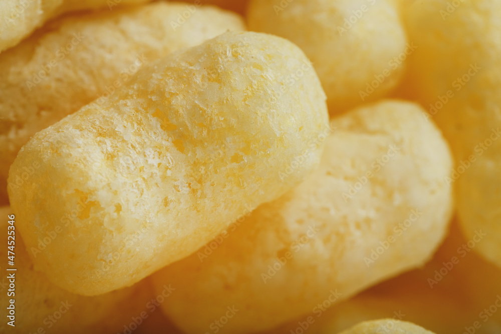 Corn sticks in powdered sugar as a texture, crispy sweets Corn sticks in powdered sugar as a texture, crispy sweets