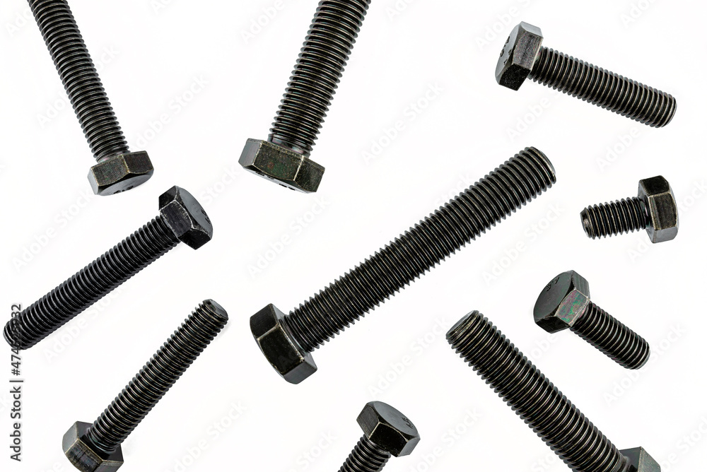 Background made of black screws with a hardness of 4.8, isolated on a white background, visible small and large screws, top view. Background made of black screws with a hardness of 4.8, isolated on a white background, visible small and large screws, top view.