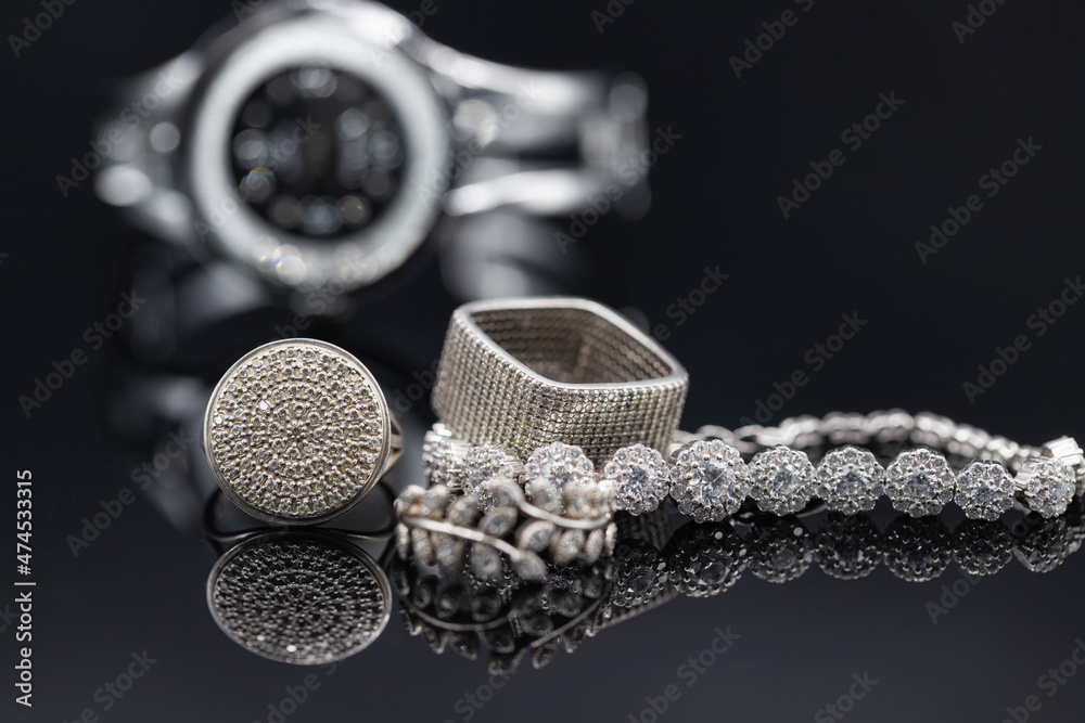 Fototapeta premium Elegant women's watches in a metal case and jewelry made of silver