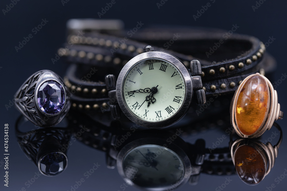 Fototapeta premium Unusual women's watches with brown leather strap and jewelry