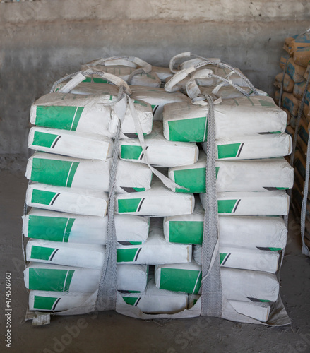 White cement bags stacked in a warehouse. Cement industry  business.