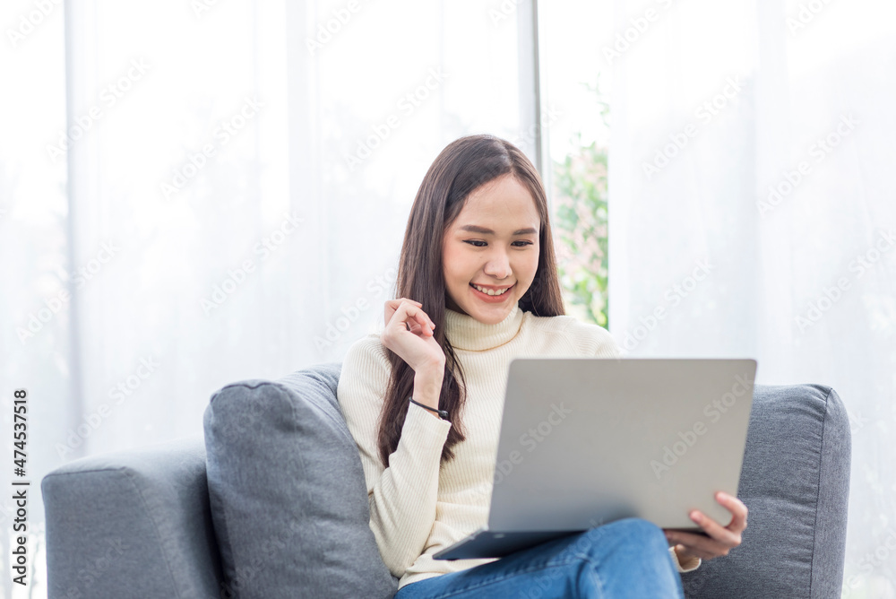 Portrait of Asian young  woman doing with computer notebook with happy in love moment in living room
