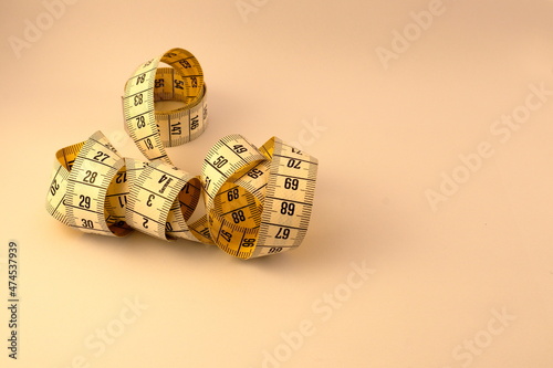 Measuring tape. Close up and isolated against a white background. A mess mixed together. The metric system with centimeters. 