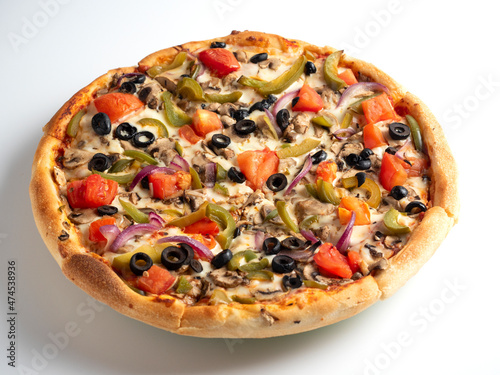 Close-up of a delicious vegetarian pizza with vegetables and mushrooms on a white background. Traditional Italian dish