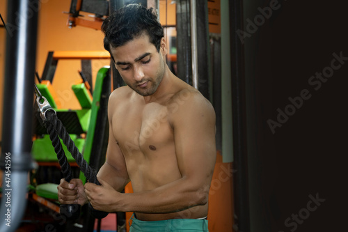 Young man doing workout in gym