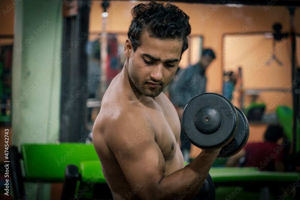 Man in gym with weight Dumbbell gym images Man in gym with weight Dumbbell gym images
