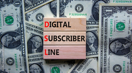 DSL digital subscriber line symbol. Concept words DSL digital subscriber line on wooden blocks. Beautiful background from dollar bills, copy space. Business and DSL digital subscriber line concept.