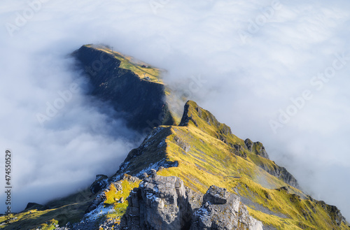 Mountains and clouds in the valley. Natural landscape high in the mountains.