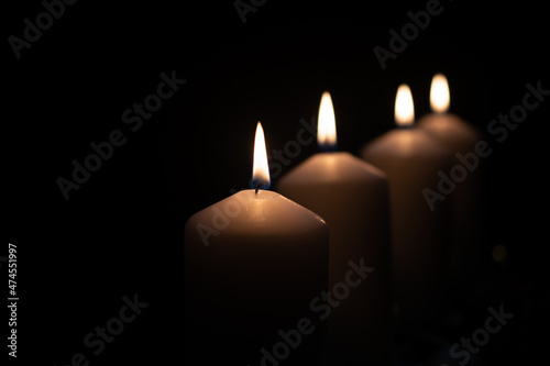 Fourth advent, four candles - candlelight on dark brown panorama background - advent banner. Horizontal banner for homepage. Template for greeting cards, funeral cards and obituaries.
