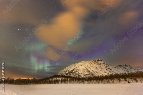 Aurora borealis with snowy mountain background