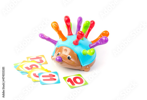 Childrens toy for the development of motor skills in the form of a hedgehog with and cards on a white background.