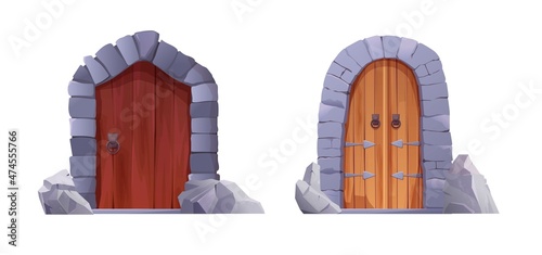 Antique medieval wooden door with metal round handle and lined with stones. Gothic entrance, gate in a castle, church or house.