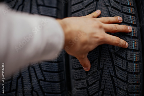 close-up of a man's hand with car tires