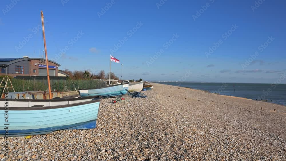 Selsey east beach with small wooden fishing boats on the shingle beach close to the Selsey Lifeboat Station. Selsey east beach with small wooden fishing boats on the shingle beach close to the Selsey Lifeboat Station.