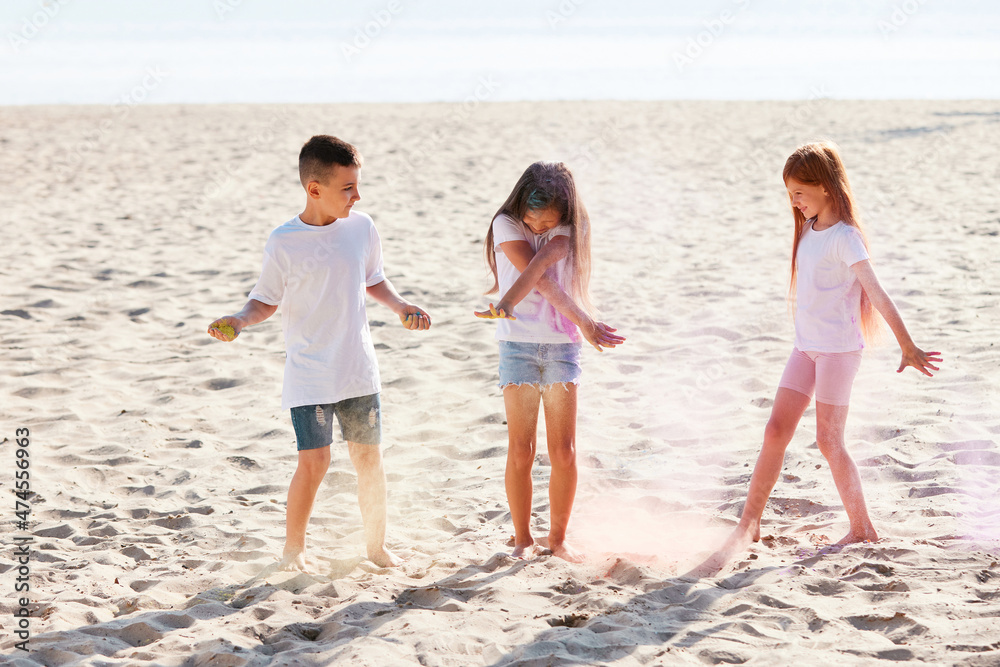 kids having fun by playing with colored powder