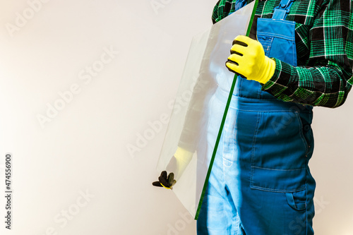 Glazier holding in his hands a piece of thick glass pane, a lot of space for text