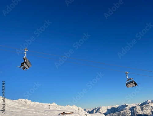 Chairlift and snow covered mountain ridge against blue sky in winter ski resort Golm, Montafon, Austria. © Maleo Photography