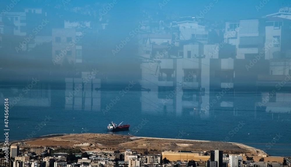 Naklejka premium ship at the port of Beirut viewed through a window with reflection