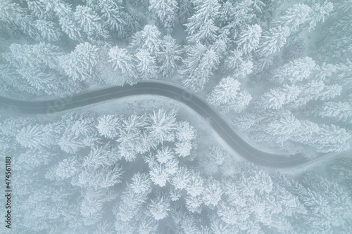 Icy Road in Winter Forest. Winter Weather. Drone View