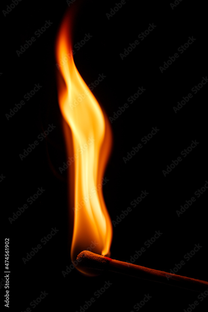 flame of a matchstick on black background flame of a matchstick on black background