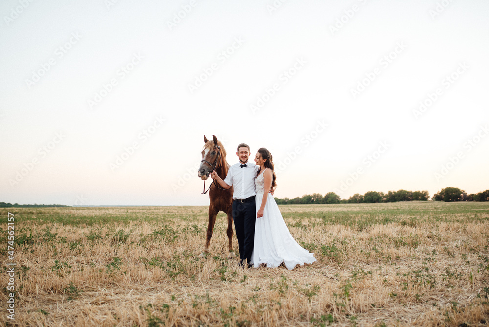 the bride in a white dress and the groom in a white shirt on a walk the bride in a white dress and the groom in a white shirt on a walk