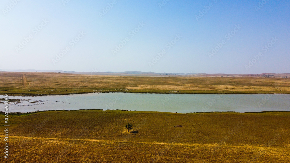 Obraz premium Wide view of Farm landscape with a lake 