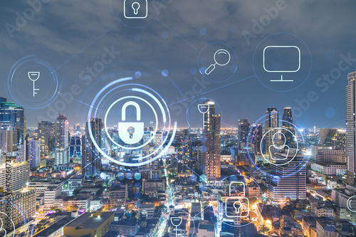 Glowing Padlock hologram, night panoramic city view of Bangkok, Southeast Asia. The concept of cyber security to protect companies. Double exposure.