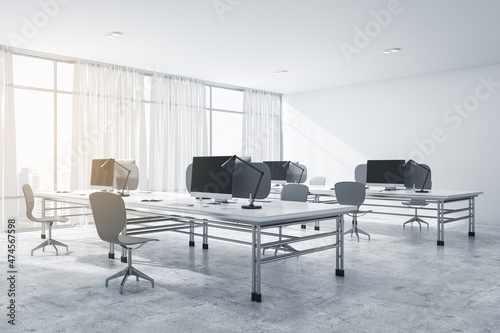 Modern concrete coworking office interior with furniture, equipment, daylight and technology. Workplace and corporation concept. 3D Rendering.