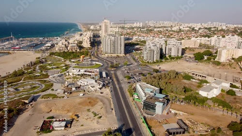 Moving down from the sky to Ashkelon city near Mediterranean sea shore and tall buildings