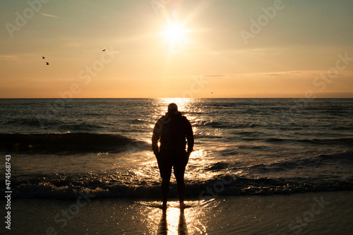 Man standing on beach during sunset
