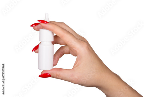 Nasal spray in hand on white background