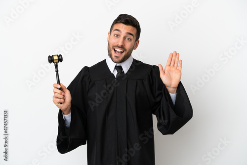 Judge caucasian man isolated on white background saluting with hand with happy expression