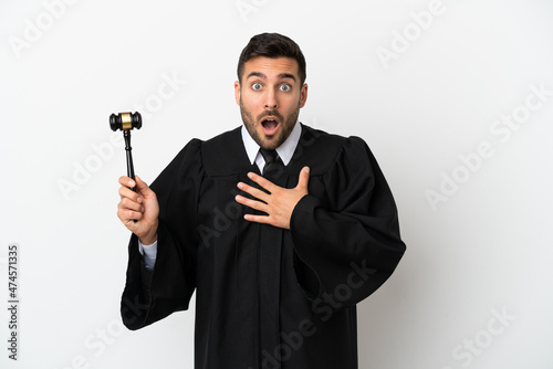 Judge caucasian man isolated on white background surprised and shocked while looking right
