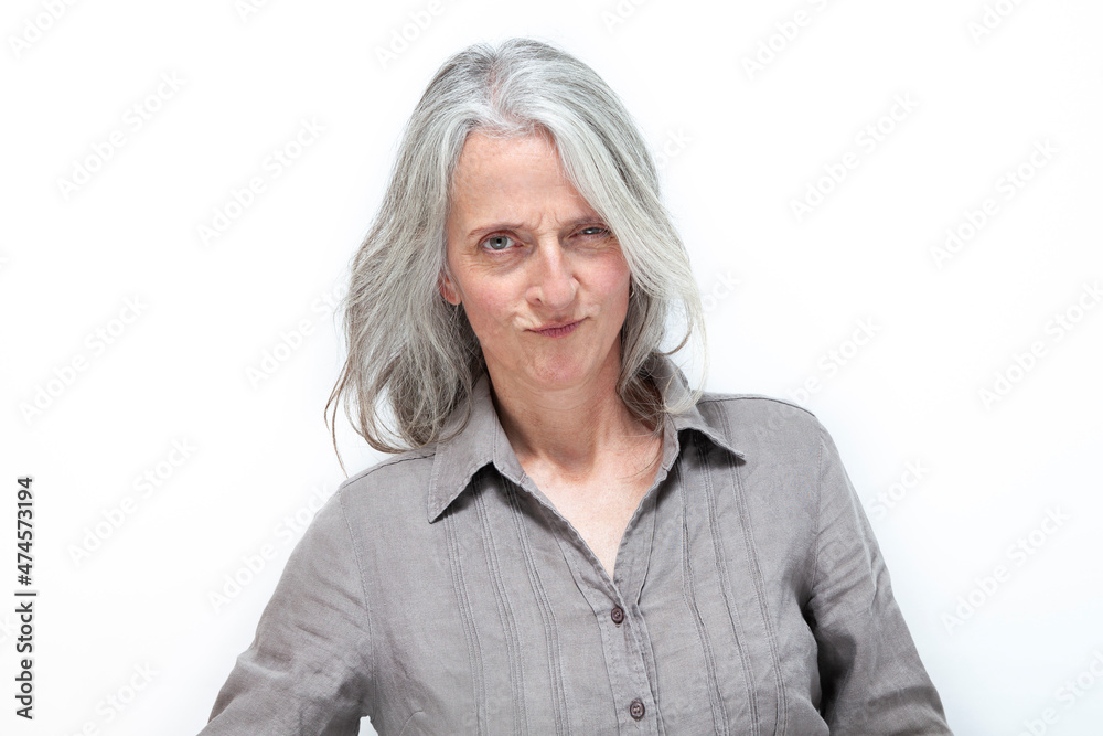 mature beautiful woman with gray hair, looking angry and inquisitive mature beautiful woman with gray hair, looking angry and inquisitive